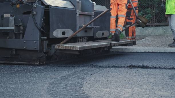 istock Road Paving Machine Roadworks Asphalt Laying Machine Operated by Workers Wearing Protective Workwear 1439432036