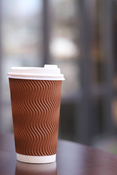 istock cup with coffee on the table, blurred background out of focus. Vertical Orientation 1439439977