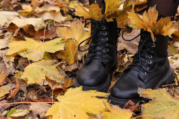 istock women's boots with autumn leaves, fall concept 1439440046