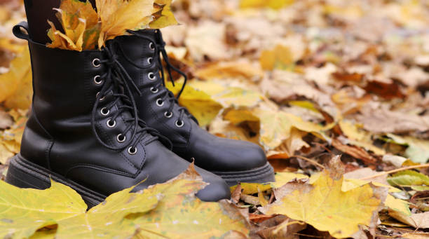 istock women's boots with autumn leaves, fall concept 1439440068