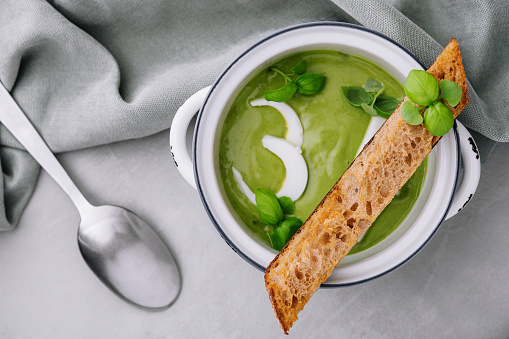 Fresh green soup on grey background