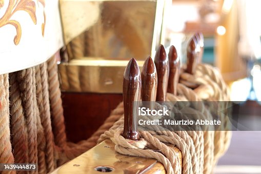 istock Mooring lines and seafaring knots of the military training ship "Amerigo Vespucci" moored on the quay in Italy. The sailing ship is the most beautiful ship in the world 1439444873