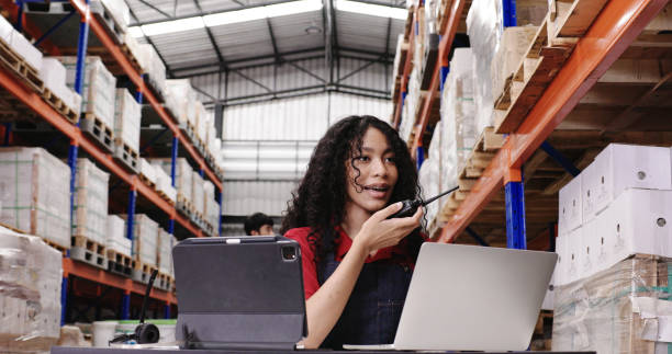 Warehouse workers are sitting at work checking products in the warehouse. Product information from the database in the laptop. shelf in the factory. professional work stock photo