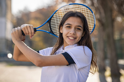 Tennis girl posing and looking at camera
