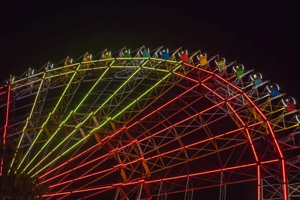 Photo of Ferris wheel at the fair ground at night