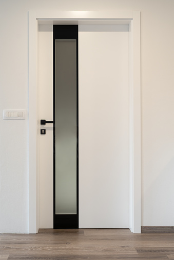 White classic interior door with a circle on a gray background. Front view. Ral 9010. Beautiful door for the house