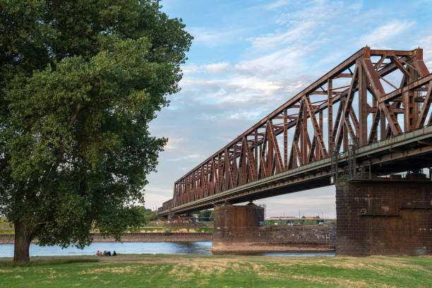 Duisburg, Germany - July 13, 2022: Old bridge crossing the Rhine river during sunset on July 13, 2022 in Duisburg, Germany