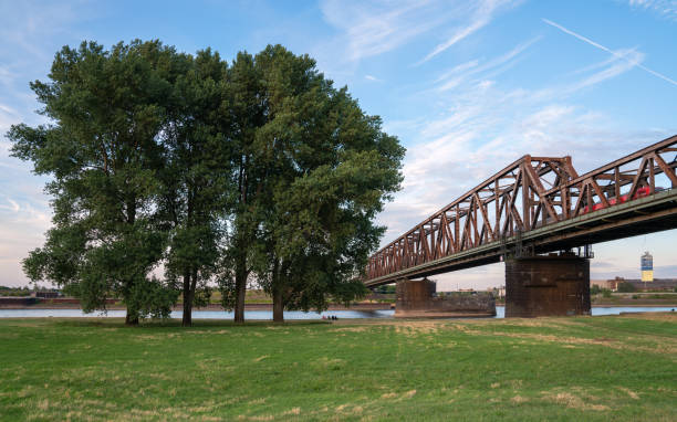 Duisburg, Germany - July 13, 2022: Old bridge crossing the Rhine river during sunset on July 13, 2022 in Duisburg, Germany