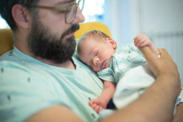 istock Father holding his newborn baby boy 1439450437