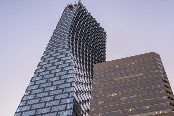 Low angle shot of Telus Sky tower captured under the blue sky in Calgary, Alberta, Canada
