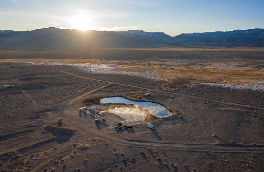 Fish Lake Valley, Nevada, United States – March 21, 2020: Campers and visitors soak in the hot springs in scenic Fish Lake Valley, near Dyer, Nevada, on a brisk morning.