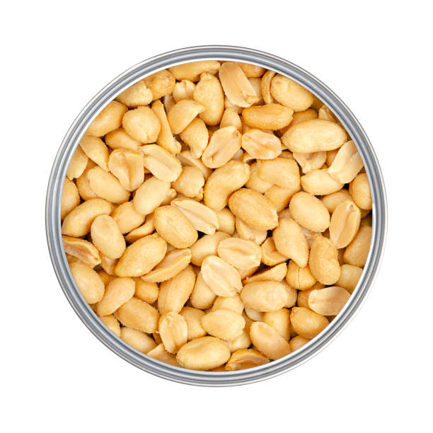 istock Roasted and salted peanuts in an opened tin can, close-up, from above 1439453300
