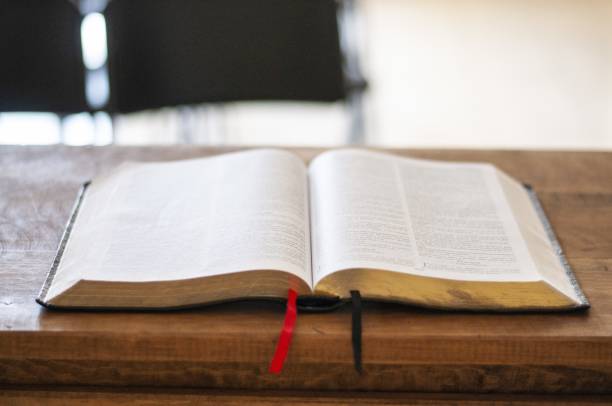 istock Selective focus shot of an open bible in the table with a blurred background 1439453367