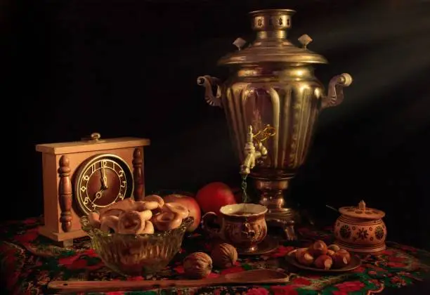 A closeup shot of a samovar in a beautiful interior setting on a black background