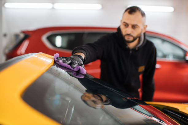 istock Selective focus on hand of car wash worker man, wearing protective gloves 1439454870