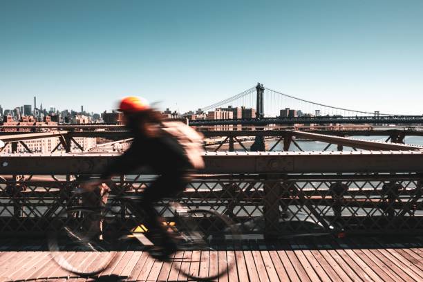 Cyclist in Brooklyn bridge Cyclist in Brooklyn bridge with NewYork as background new york marathon photos stock pictures, royalty-free photos & images
