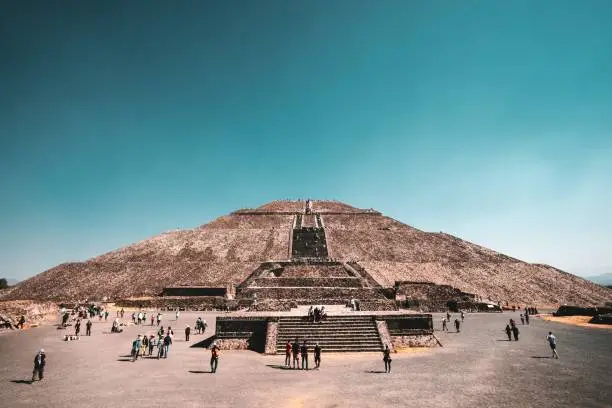 A low angle shot of The Pyramid of the Sun in Teotihuacan, Mexico with a clear sky in the background