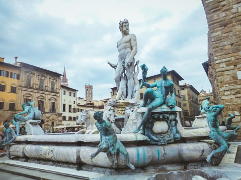 Rome, Italy - October 11, 2007: The Fountain of Neptune in Piazza Navona designed in 1574 by Giacomo Della Porta. The popular Piazza Novona in Rome goes back to ancient Roman times when it was the site of the Stadium of Domitian which was built in the first Century AD. The Piazza was transformed into a significant example of Baroque Roman Architecture during the reign of Pope Innocent X who reigned from 1644 to 1655 AD. Today it is a very popular Roman square where many artists display their paintings for sale to visitors. Photo shot in the afternoon sunlight; horizontal format.