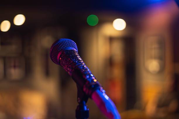 istock Closeup shot of a microphone on a blurred background with bokeh lights 1439456602