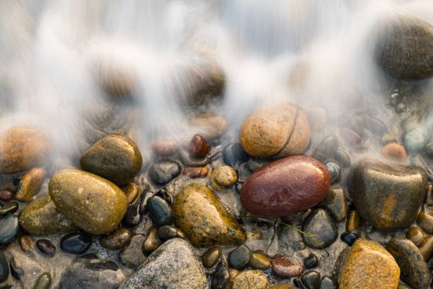 istock Closeup shot of pebbles covered with seafoam 1439456925