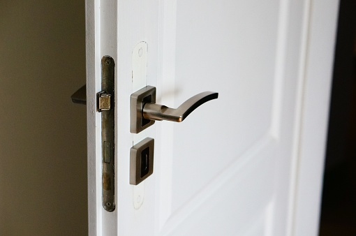 A closeup shot of a modern doorknob with a blurred background