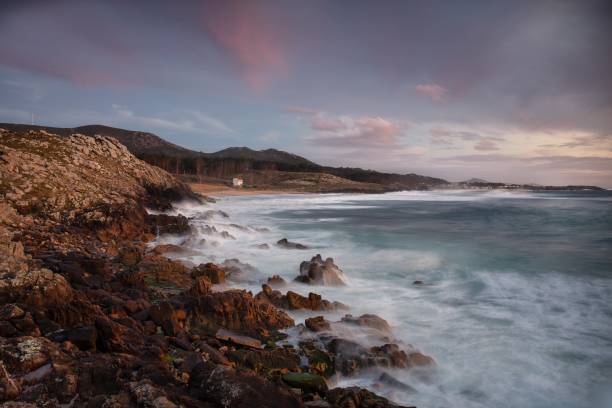 istock Coastline with stones on the shore during sunset 1439457608