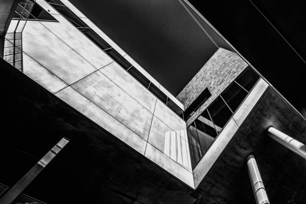 istock Greyscale low angle shot of a building with cool design 1439459127