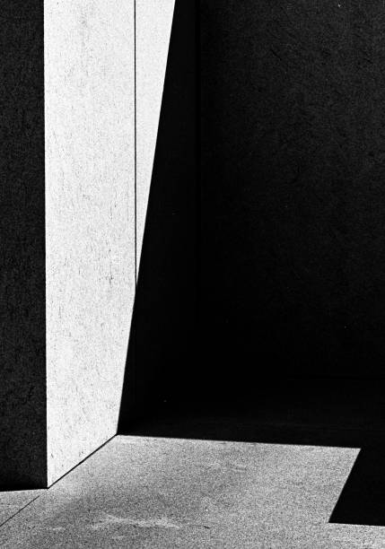 istock Greyscale vertical picture of a building corner with shadows - an abstract background 1439459393