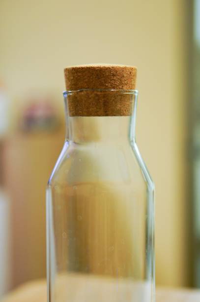 istock Closeup selective focus shot of an empty bottle with cork in it on a yellow background 1439459813