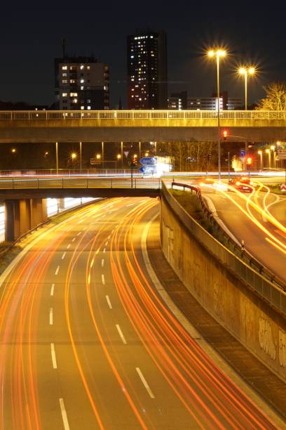 istock Vertical high angle shot of an illuminated highway at night 1439459964