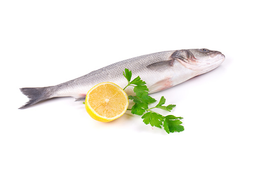 Fresh seabass with lemon. Isolated on a white background. Close-up.