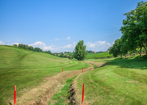 Golf course at the country side. Sand bunkers at the beautiful at sunset, sunrise time.Beautiful view landscape in evening time green grass at golf course.