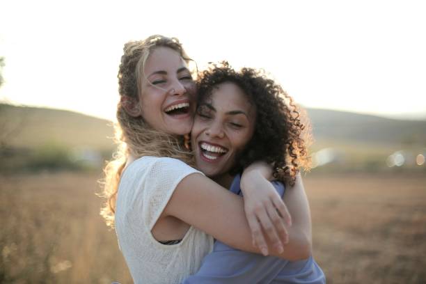istock Female friends hugging each other surrounded by a dry field 1439462308