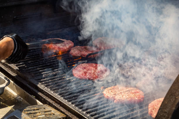 istock Hamburger cutlets are fried in smoke on a grill grate 1439464051