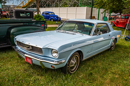 Des Moines, IA - July 01, 2022: High perspective front corner view of a 1966 Ford Mustang 2 Door Hardtop at a local car show.