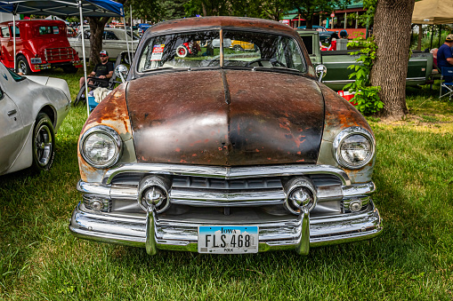 Des Moines, IA - July 01, 2022: High perspective front view of a 1951 Ford Custom Tudor Sedan at a local car show.
