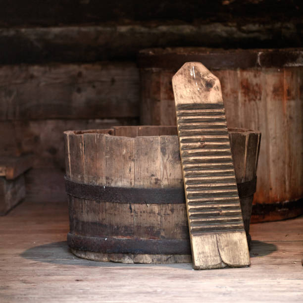 istock Authentic old laundry wringer washboard in a wooden half barrel tub 1439470000