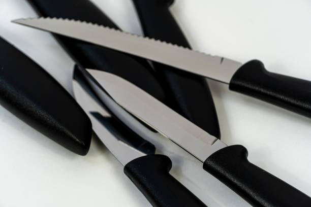 istock Top view of multiple sharpened knives with black handles and metallic blade 1439472295