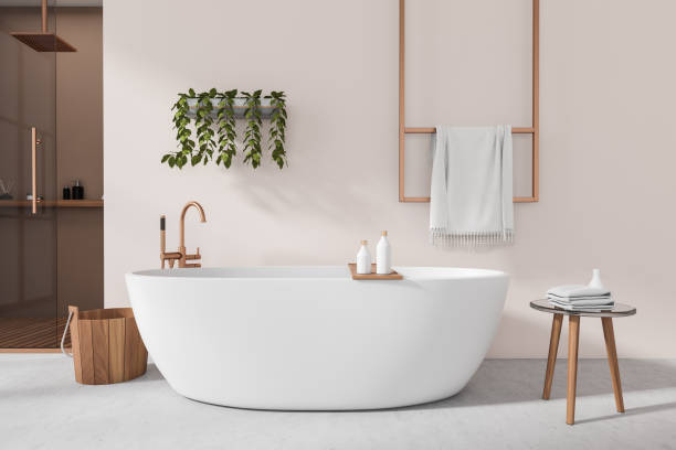 istock Front view on bright bathroom interior with bathtub, stool, towels 1439476713
