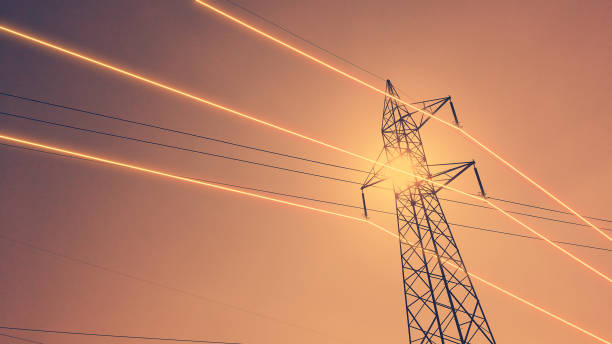 istock Electricity transmission towers with glowing wires 1439482450