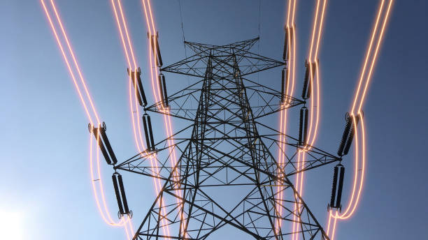 istock Electricity transmission towers with glowing wires 1439482504
