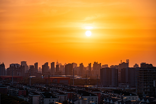 In Shanghai at dusk, the sky is dyed orange by the sunset glow.