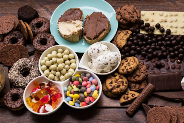 istock Chocolate cream on a bread and colorful sweets and candies 1439482649