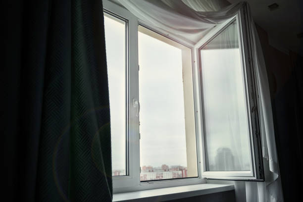 istock Plastic window frame is open in urban apartment or office room. 1439484130