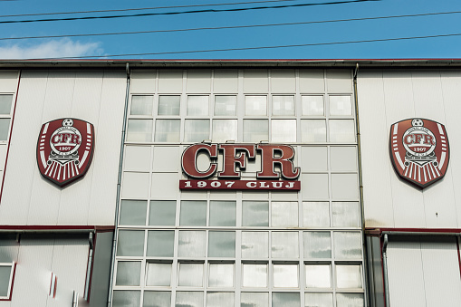 Cluj-Napoca, Romania - JUL 09, 2021: CFR soccer club building with official football symbol on the exterior