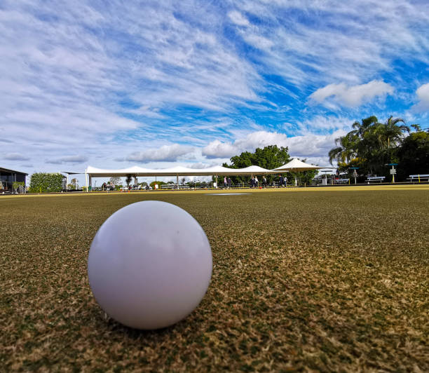 White bowling ball for barefoot lawn bowling in sunny day with blue sky white cloud