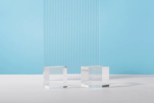 Acrylic plate, podium solid blocks, background for cosmetic product packaging on blue with stylish props. Showcase for jewellery presentation, display for advertising, cosmetics branding scene mockup