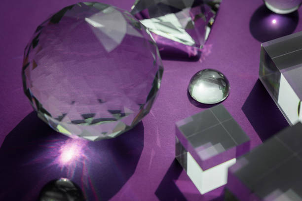 istock Crystal prism refracting light, magic crystals and pyramid, sphere and cube on purple background. Spiritual healing crystal practice. Feng Shui, good energy flow concept, esoteric background 1439487908