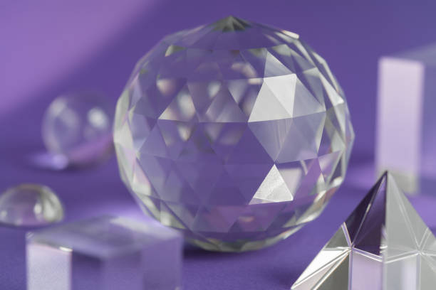 istock Crystal prism refracting light, magic crystals and pyramid, sphere and cube on purple background. Spiritual healing crystal practice. Feng Shui, good energy flow concept, esoteric background 1439487925
