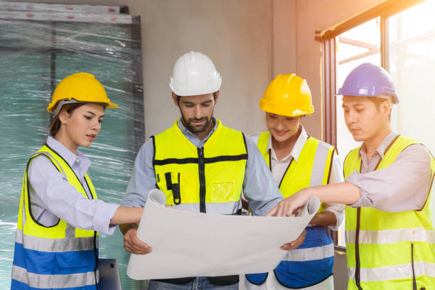 istock group of construction worker team working together discussion looking floor plan at construction site planning build process 1439489036
